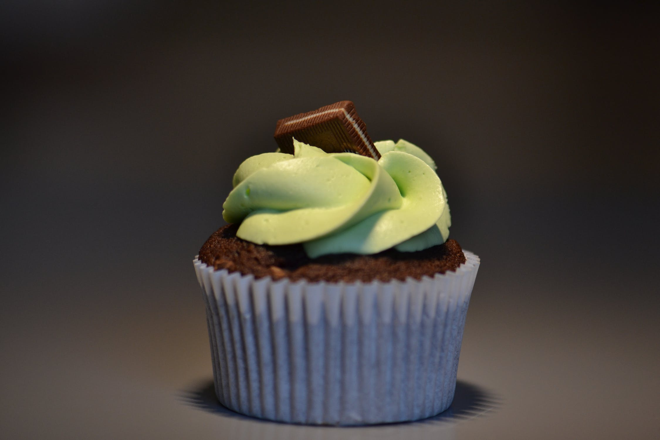 chocolate cupcake with mint cream and a piece of chocolate